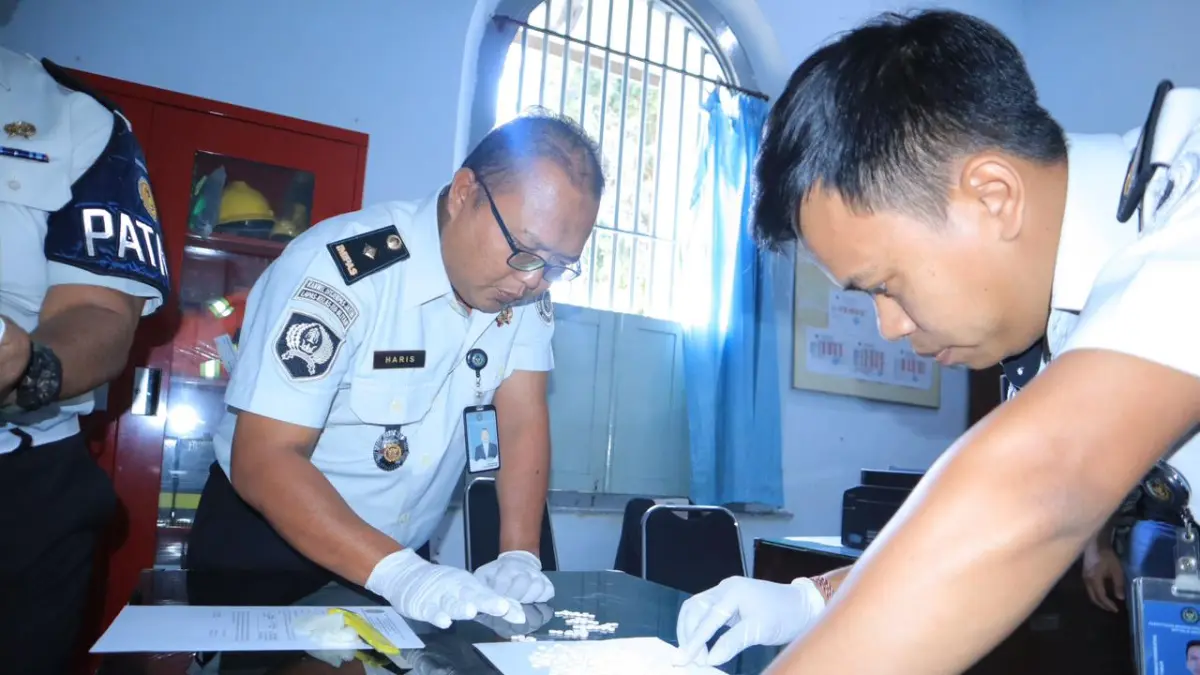 HITUNG BARBUK: Petugas Lapas Kelas IIB Blitar menghitung barang bukti pil dobel L yang hendak diedarkan di dalam lapas. Tiga warga binaan ditetapkan sebagai tersangka setelah diduga mengendalikan peredaran pil koplo dari balik penjara. 