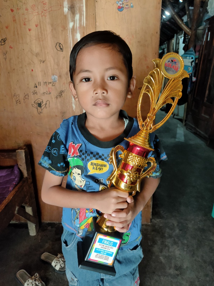 PUNYA KARTU UNTUK BERMAIN: Setya Budi Aji membawa piala finalis Festival Kolase 2023. (IST/RDR.LMG)