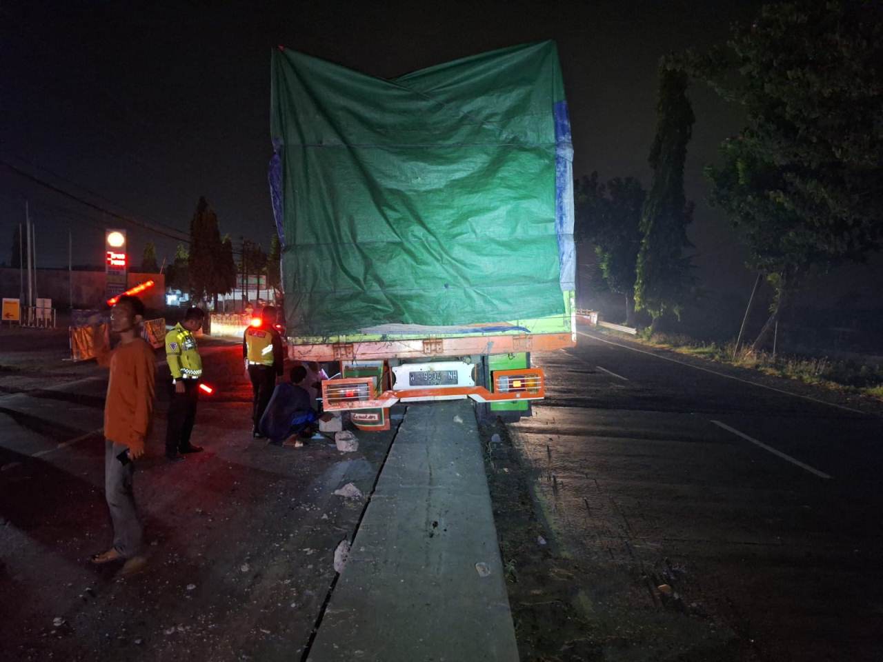 MINIM PENERANGAN: Truk W 9804 NH yang bermuatan kacang tanah naik ke median jalan nasional Lamongan &ndash; Gresik. (GAMAL A/RDR.LMG)