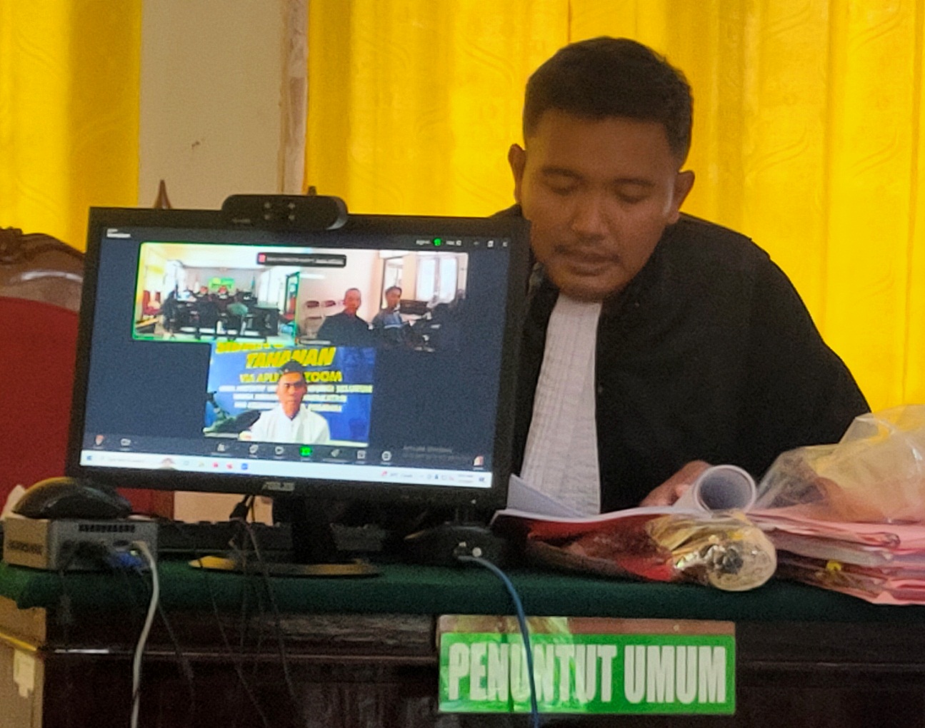 HADIRKAN SAKSI: JPU Eko Vitiyandono membaca berkas dalam sidang secara online kasus pencurian uang kotak amal masjid. (IST/RDR.LMG)