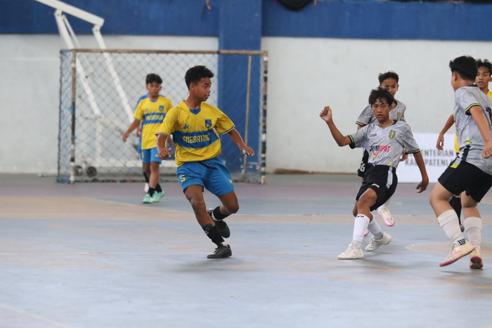 PERSAINGAN TOP SKOR : Pemain SMPN 1 Turi, M Alif Sofkhal (5) dikawal pemain SMP Muhammadiyah 14 Karangasem. (Anjar/Radar Lamongan)