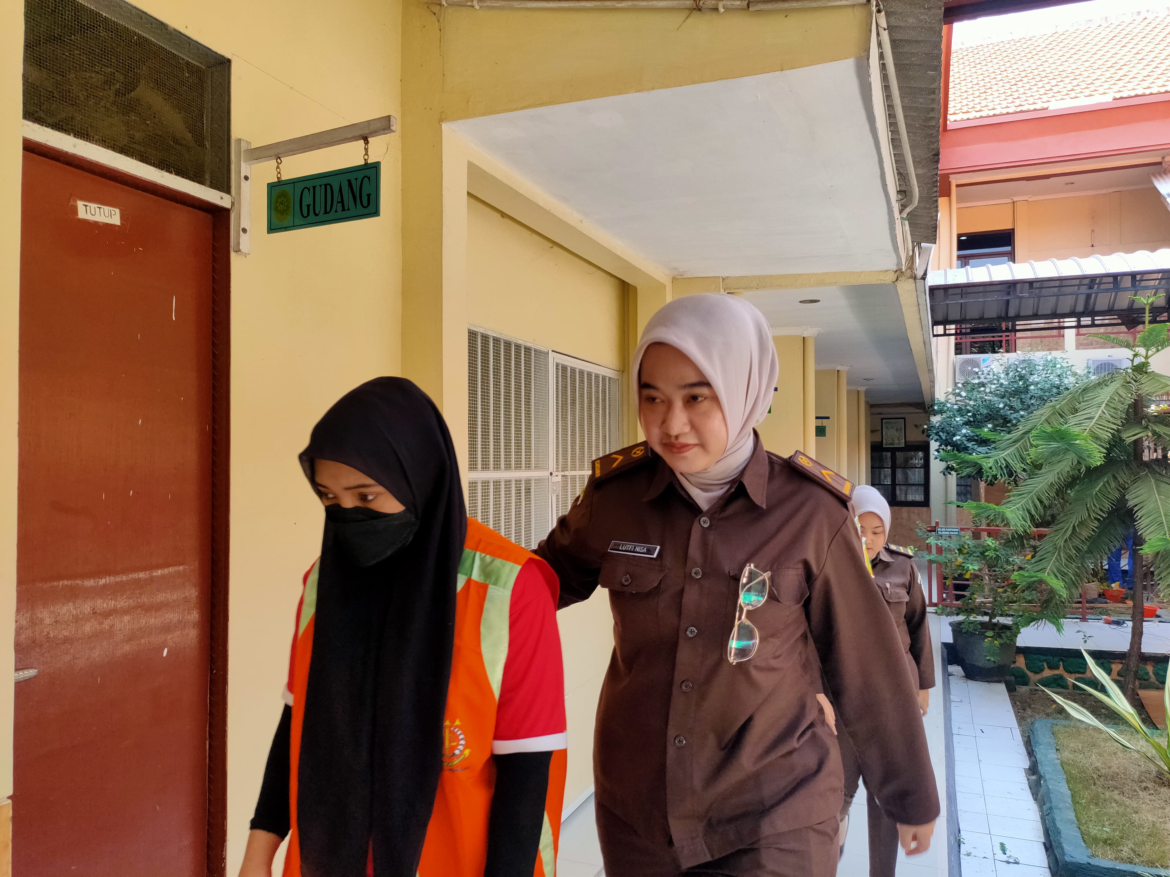 DIVONIS 18 TAHUN: Nur Fadillah dikawal petugas sebelum menjalani sidang perdananya. Dia kemarin divonis 18 tahun.(IST/RADAR LAMONGAN)