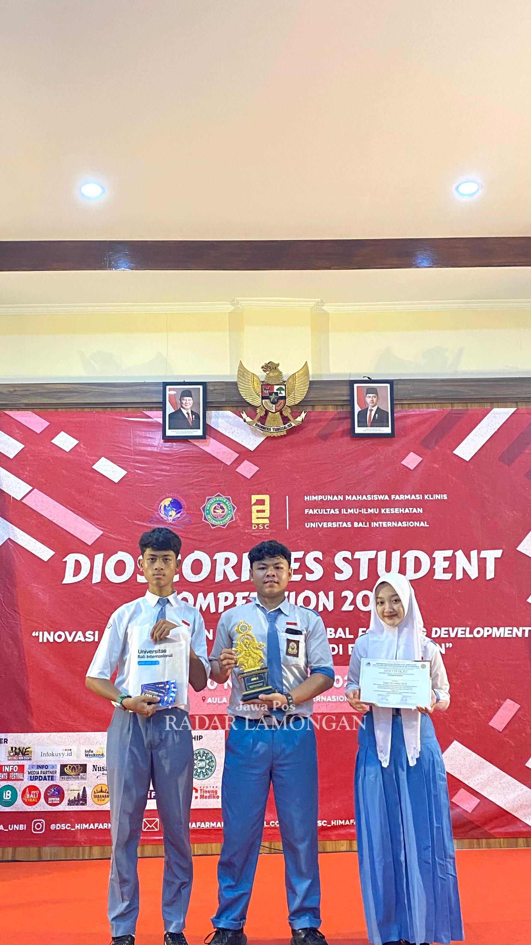 RAIH JUARA 2: Tiga pelajar SMAN 1 Lamongan meraih juara 2 lomba KTI tingkat nasional di Universitas Bali Internasional. (IST/RADAR LAMONGAN)