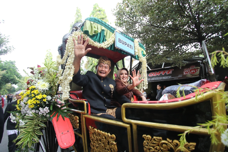 RAMAH: Bupati Yes dan istri menyapa masyarakat yang antusias menyaksikan kirab pataka.