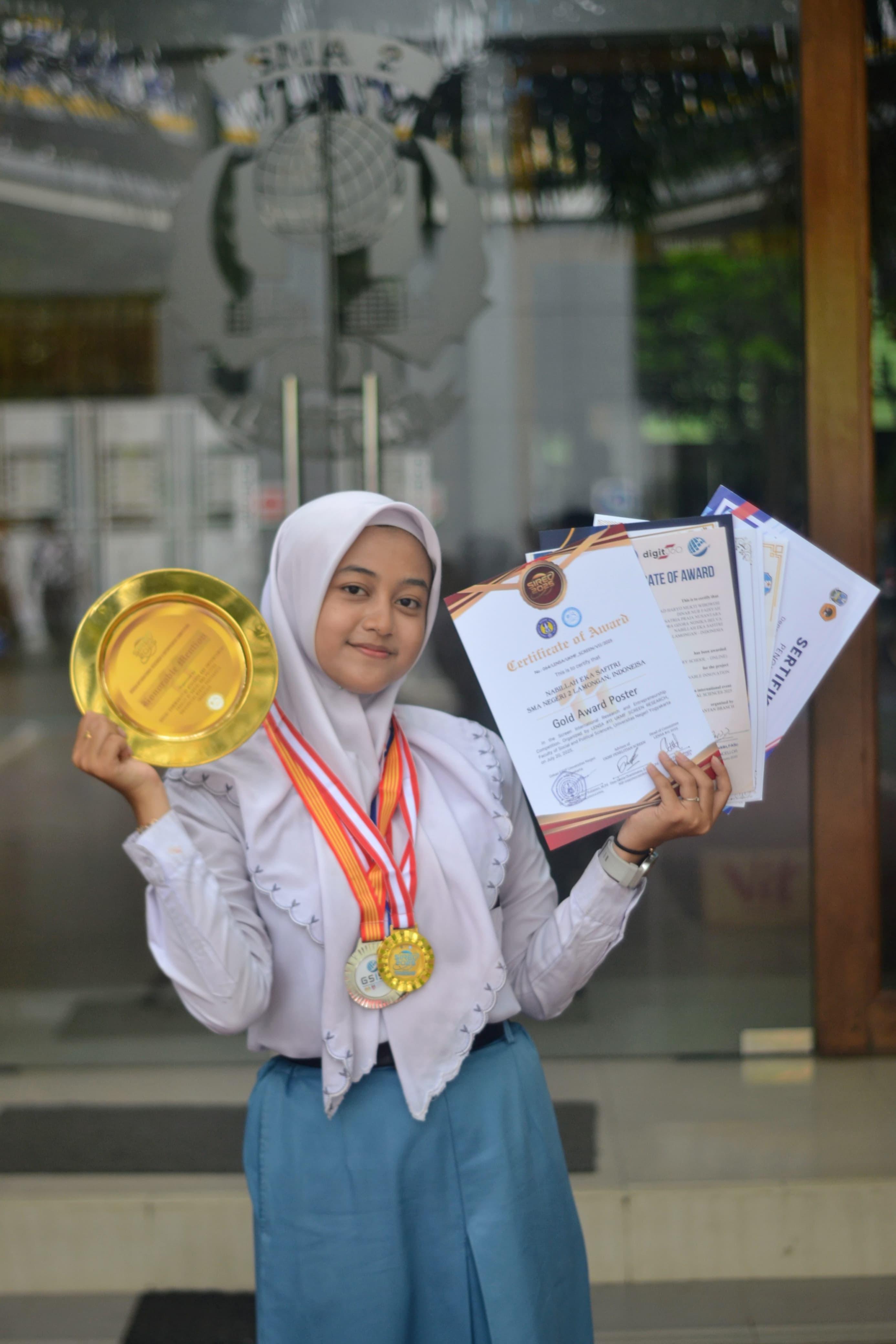 BERPRESTASI: Nabillah Eka Safitri menunjukkan piagam penghargaan dan medali yang diraihnya . (IST/RDR.LMG)