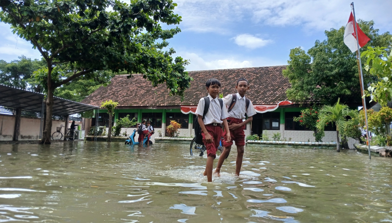 Sejumlah siswa-siswi SD di salah satu SD tetap semangat belajar di tengah gedung sekolah yang terendam.
