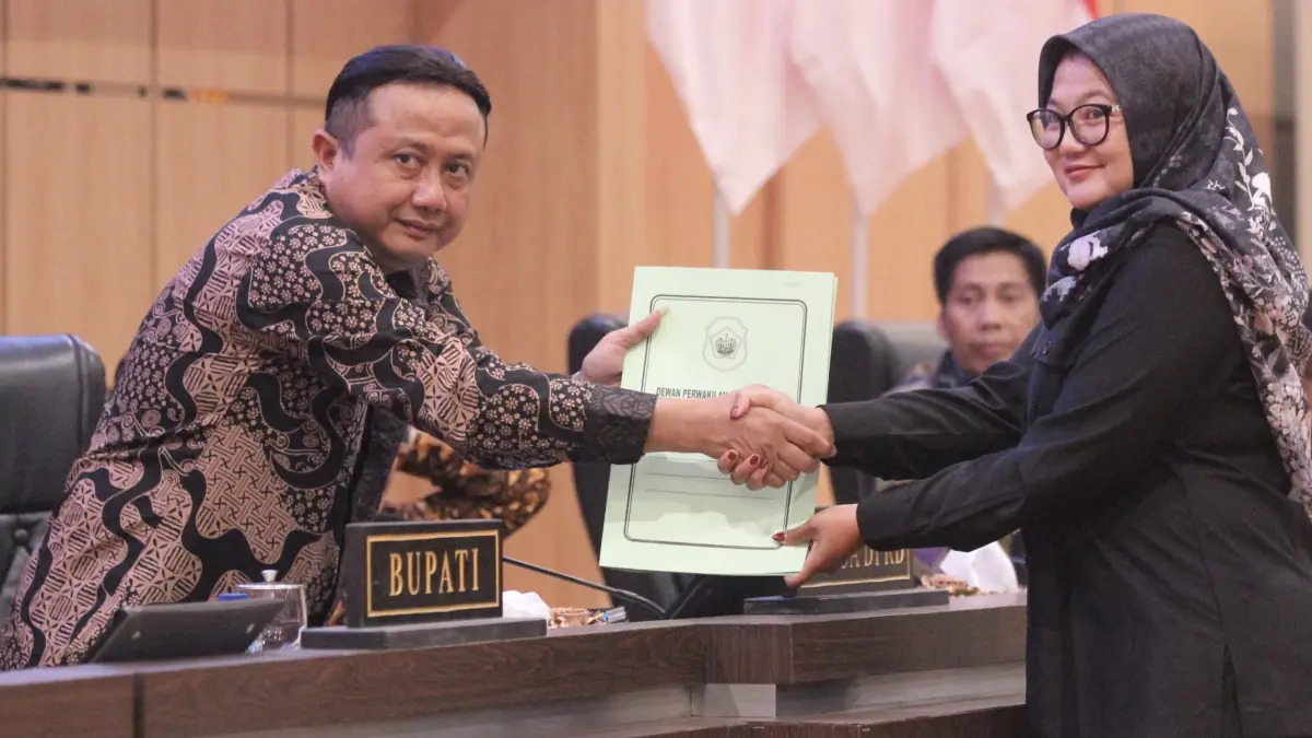 Jubir F-PDI Perjuangan, Erna Sujarwati menyerahkan draf pandangan umum kepada Ketua DPRD Lamongan, M. Freddy Wahyudi.&nbsp;(AHMAD ASIP/RADAR LAMONGAN)