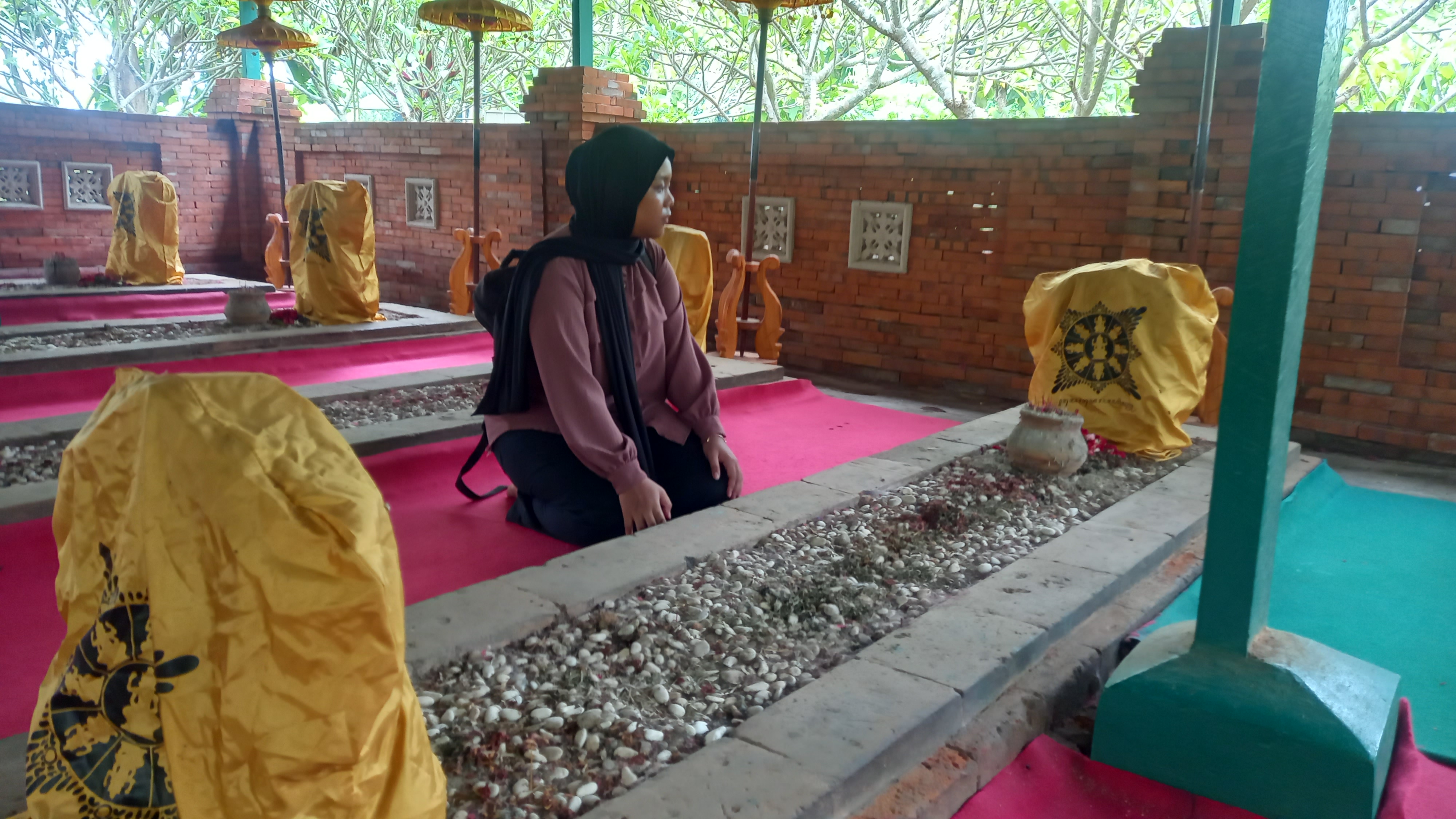 KERAMAT: Peziarah mengamati Makam Tujuh Troloyo, Dusun Sidodadi, Desa Sentonorejo, Kecamatan Trowulan, Kabupaten Mojokerto. (foto: Laila Ramadani for Radar Majapahit)