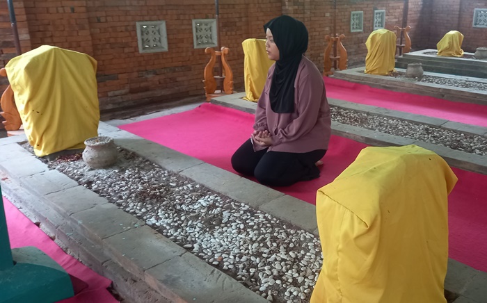 KERAMAT: Pengunjung melihat kondisi Makam Pangeran Noto Kusumo di area Kubur Pitu Troloyo, Desa Sentonorejo, Kecamatan Trowulan, Kabupaten Mojokerto. (foto: Laila Ramadani for Radar Majapahit)