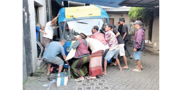 TRAGIS: Sejumlah warga mencoba mengevakuasi tubuh korban yang terjepit badan bus tayo atau odong-odong Rabu lalu (23/4). (POLSEK BUMIAJI FOR RADAR BATU)