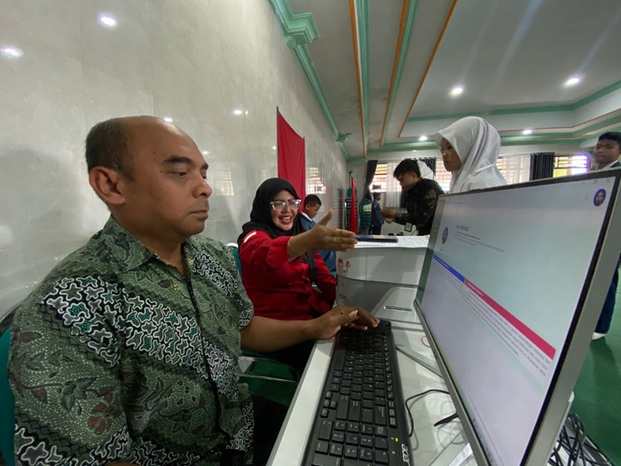 PANTAU DATA: Salah seorang operator Dispendukcapil Kota Batu sedang membuka laman SIAK beberapa waktu lalu.