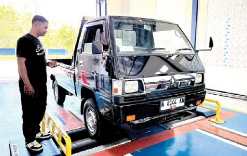 DIBERI ARAHAN: Salah seorang petugas uji KIR di Balai Pengujian Kendaraan Kota Batu sekaligus melakukan sosialisasi penertiban ODOL mulai 2027 mendatang.