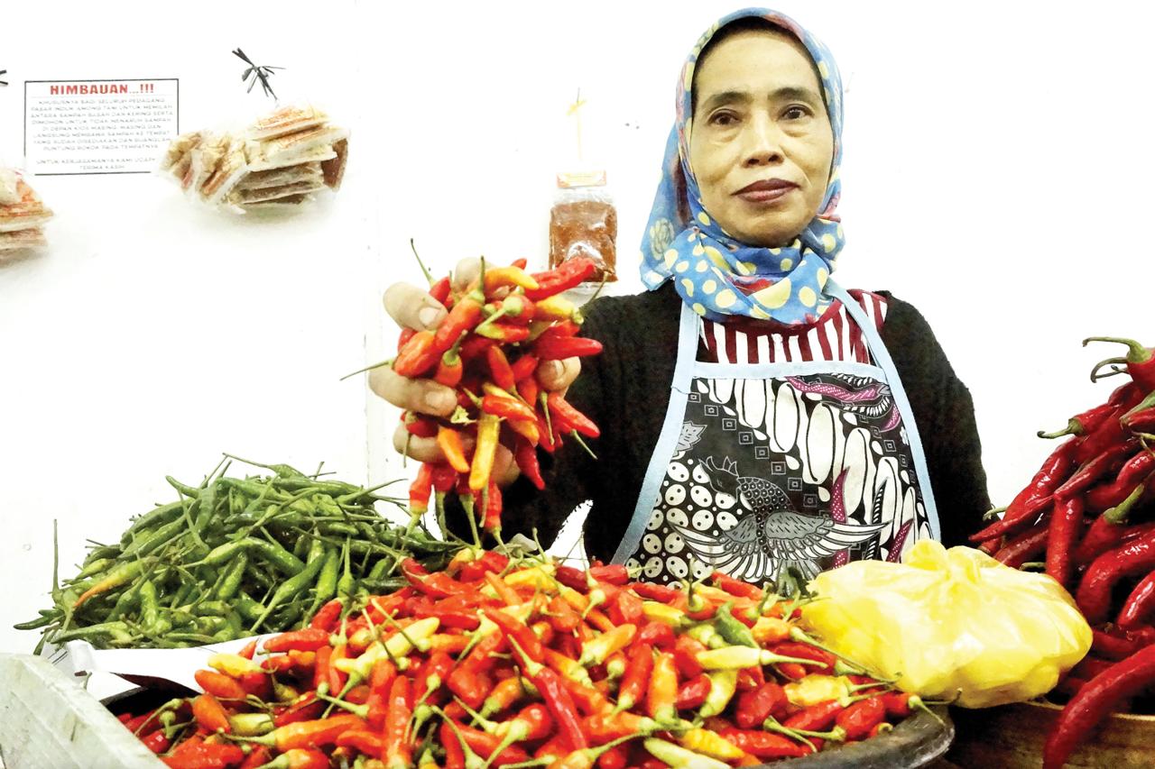 HARGA MEROKET: Salah seorang pedagang di Pasar Induk Among Tani Batu melayani pembeli kemarin (11/2).