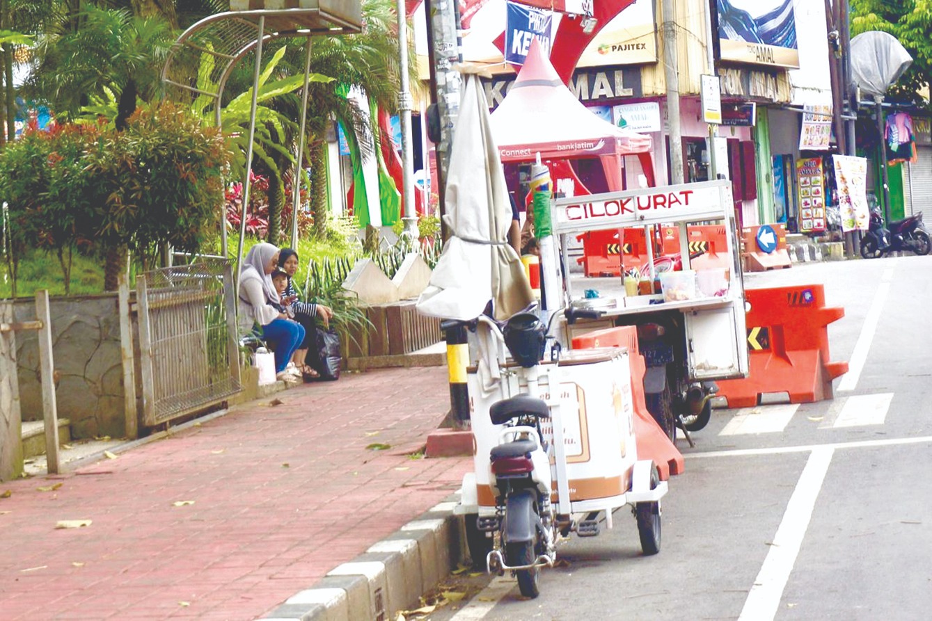 ZONA PELANGGARAN: Sejumlah PKL liar masih berjualan di sisi utara Alun-Alun Kota Wisata Batu kemarin (18/2).