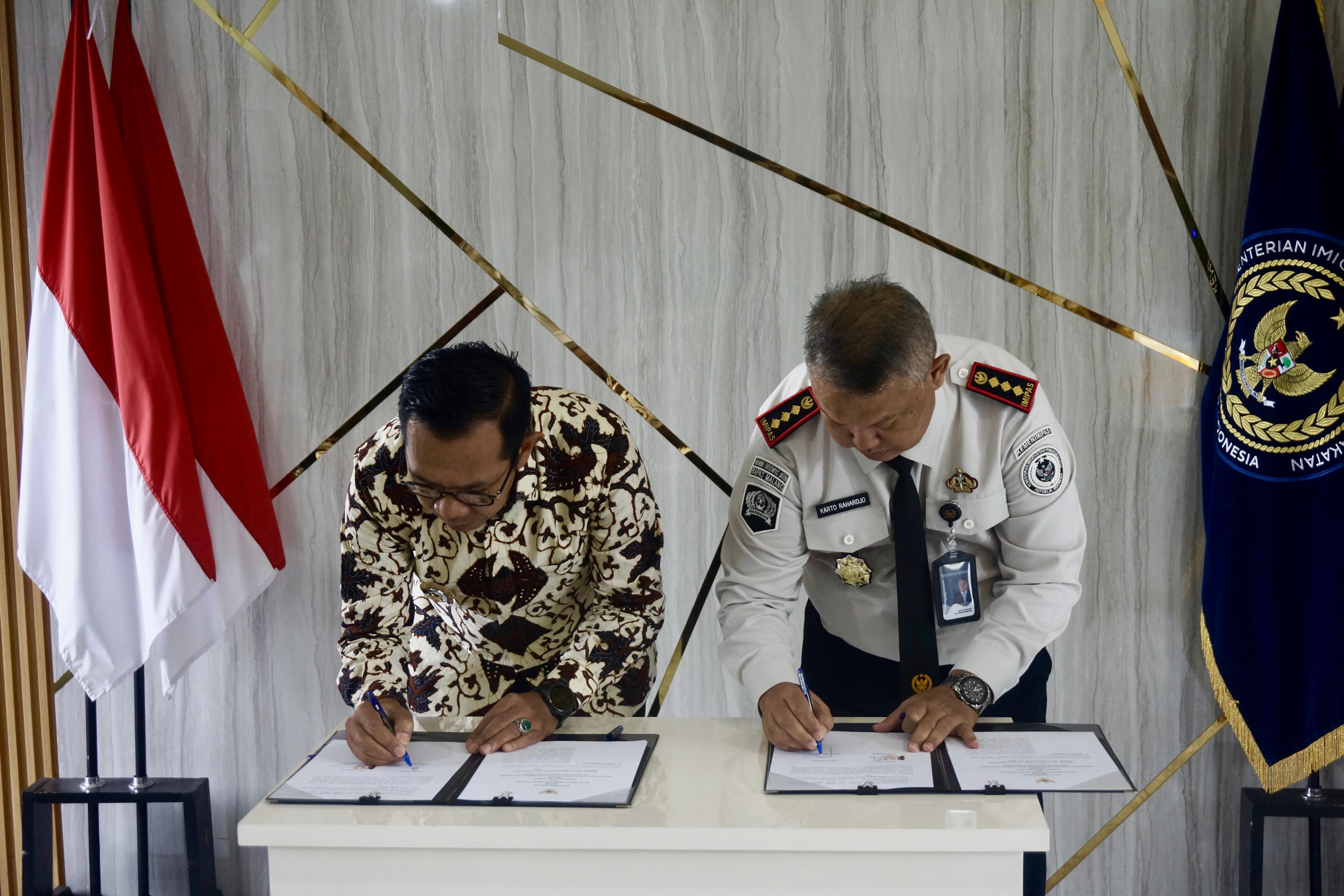 JALIN KERJA SAMA: Wali Kota Batu Nurochman (kiri) dan Kepala Bapas Kelas I Malang Karto Rahardjo menandatangani nota kesepakatan di Kantor Bapas Kelas I Malang kemarin (26/2).