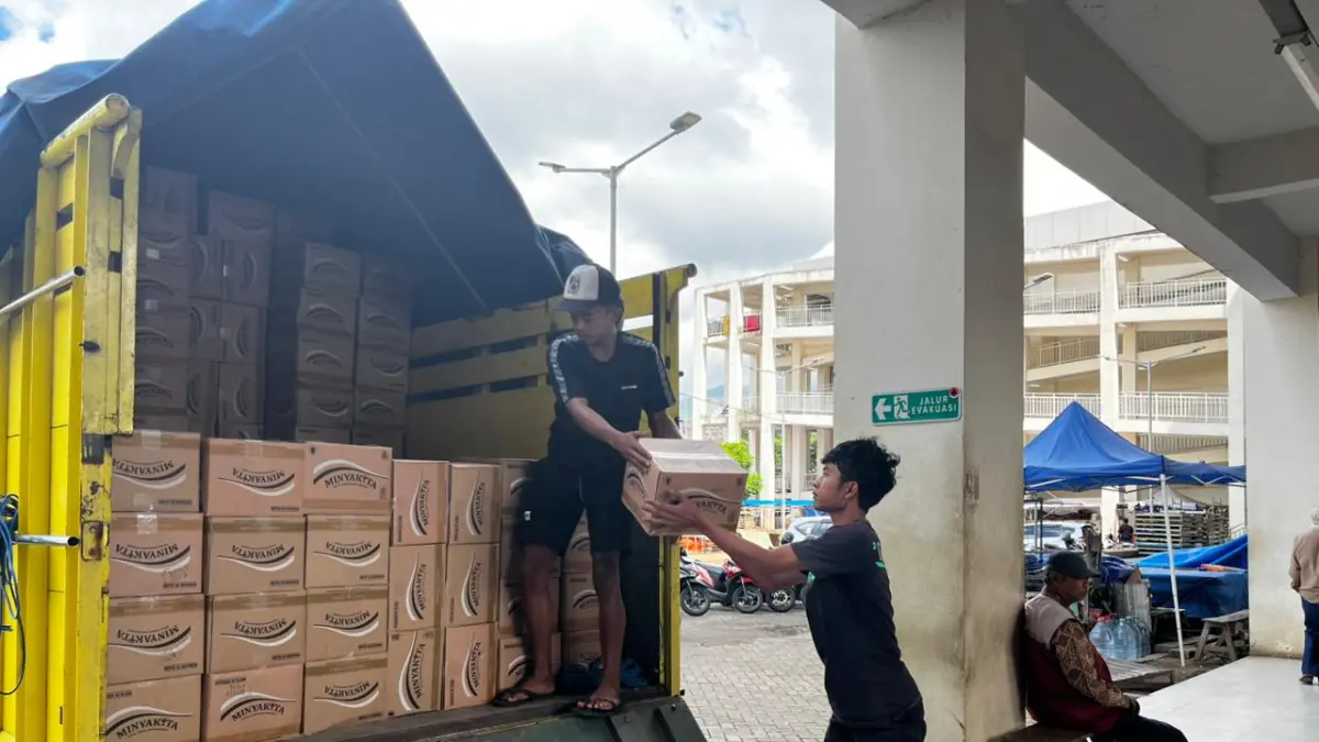 PROSES DISTRIBUSI: Sejumlah orang menurunkan kardus Minyakita untuk didistribusikan kepada 43 pedagang di Pasar Induk Among Tani kemarin (29/4). 