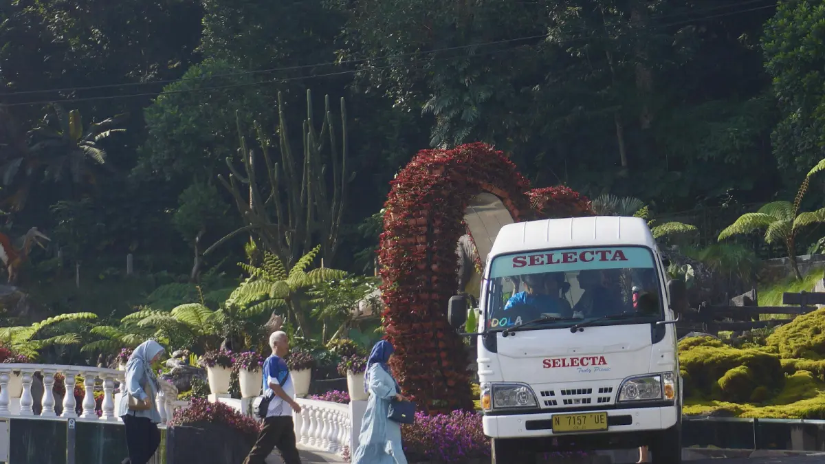 BELUM TERPENGARUH: Beberapa wisatawan antusias menaiki shuttle wisata di Taman Rekreasi Selecta kemarin (16/6).