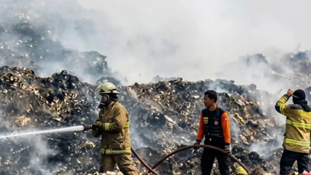Petugas Pemadam Kebakaran dibantu dengan dua halikopter milik BNPB memadamkan titik api di TPA Jatiwaringin. (Istimewa).
