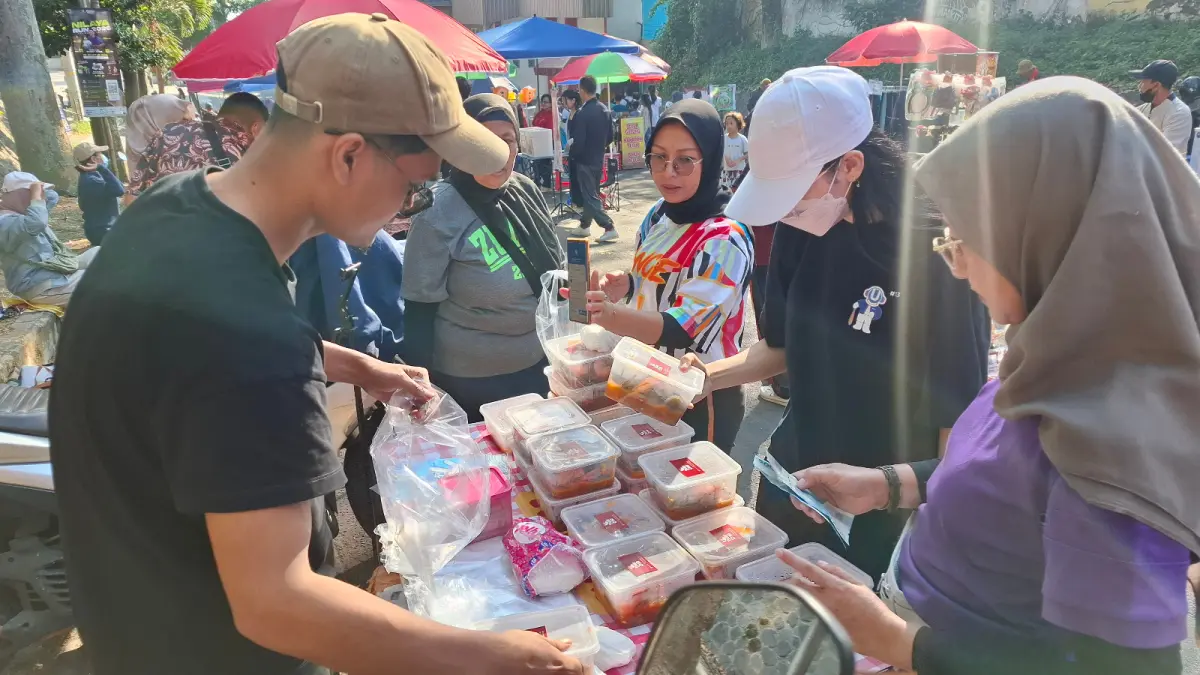 LARI MANIS: Pedagang sate tahu usus diserbu pengunjungan CFD Mbatu Sae setelah senam zumba bersama di area Stadion Gelora Brantas kemarin pagi (5/7).