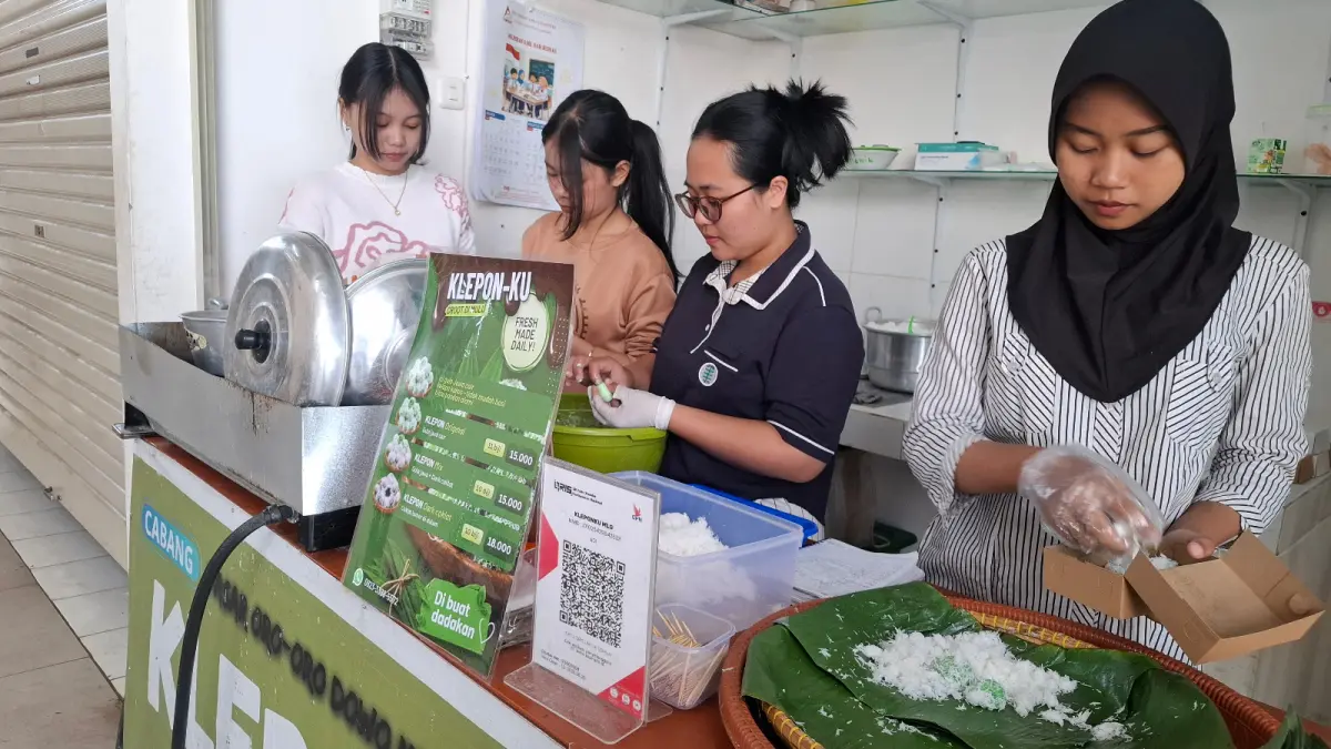 MELAYANI QRIS: Beberapa kru salah satu kios kuliner di Pasar Induk Among Tani Kota Batu tampak sibuk menyiapkan pesanan pelanggan beberapa hari lalu. Kios tersebut sudah dilengkapi layanan pembayaran berbasis QRIS.