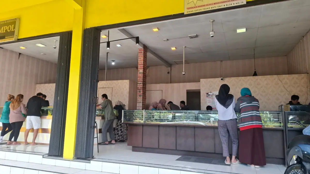 TURUN HARGA: Sejumlah pelanggan Toko Emas Agung di Jalan Sultan Agung, Kelurahan, Sisir, Kecamatan Batu memilih-milih perhiasan. Sebagian dari mereka melakukan transaksi jual kembali kemarin (24/7).
