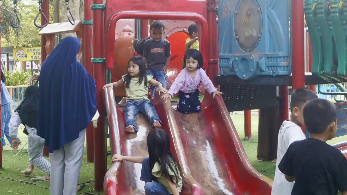 WAHANA RAMAH ANAK: Sejumlah anak-anak bermain di playground Alun-Alun Kota Wisata Batu didampingi orang tuanya beberapa hari lalu. (RORI DINANDA BESTARI/RADAR BATU)