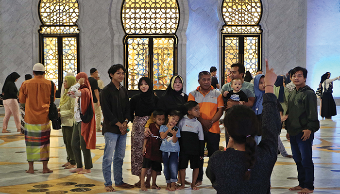 Pengunjung yang berfoto saat berwisata sambil beribadah.