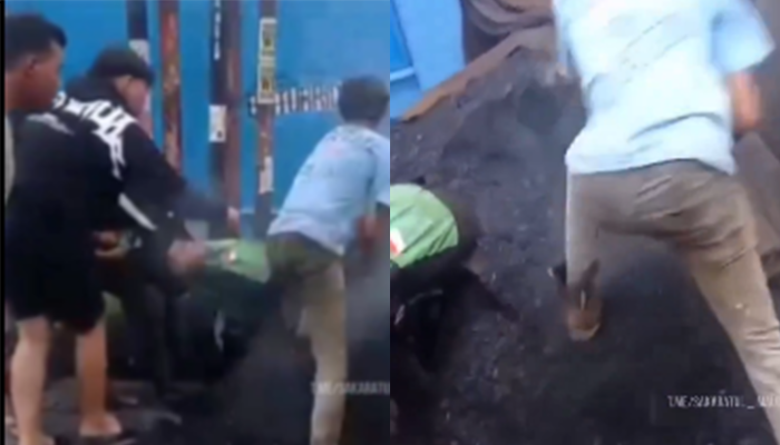 Tangkapan layar video viral driver ojol tertimbun aspal panas.