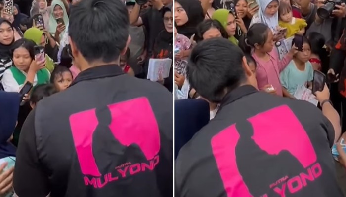 Kaesang bagi-bagu susu pakai rompi bertuliskan Putra Mulyono.