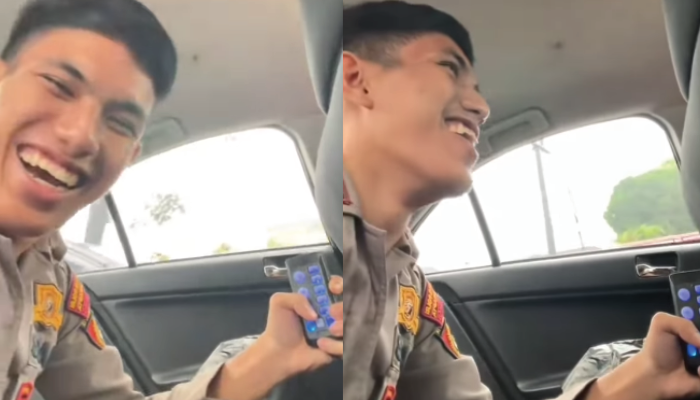 Oknum polisi nyengir saat bunyikan sirine di jalanan.
