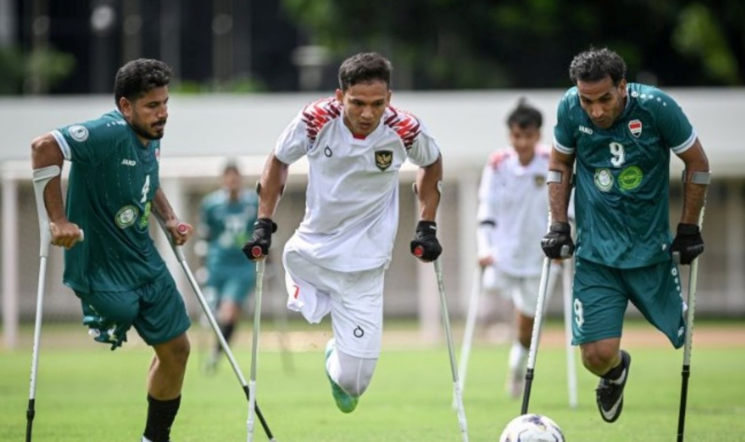Pesepak bola Timnas Amputasi Indonesia Agung Rizki Satria (tengah) berusaha melewati adangan pesepak bola Timnas Amputasi Irak dalam laga Piala Asia Amputasi 2025 di Stadion Madya, Kompleks GBK.