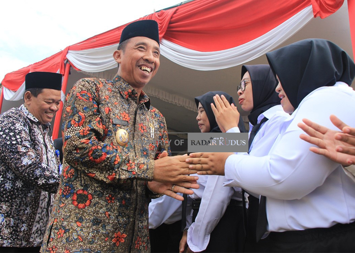 SUMRINGAH: Bupati Rembang Abdul Hafidz bersama kepala BKD memberikan ucapan selamat kepada para penerima Surat Keputusan (SK) Jabatan Fungsional tenaga guru di Alun-Alun Rembang.