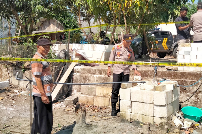 AMANKAN LOKASI: Polisi memasang police line di area sumur yang mengeluarkan gas di Dukuh Sridadi, Desa/kecamatan Pamotan, Rembang.