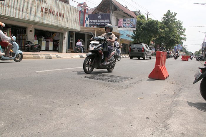 BERBAHAYA: Kondisi Jalan Sunan Kudus bergelombang dipasang water barrier.