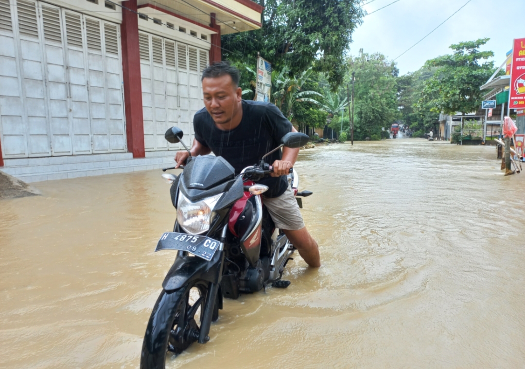 MACET: Kendaraan salah seorang warga mogok usai mencoba melewati ruas jalan di Grobogan yang terdampak banjir.