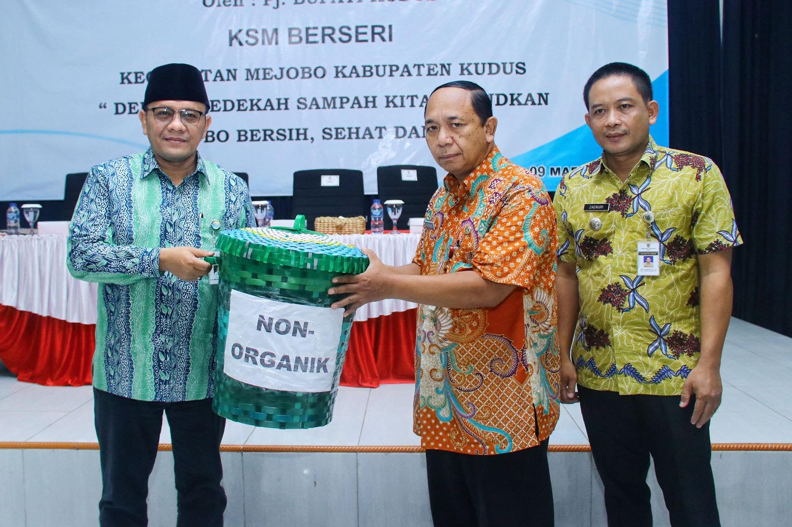 SIMBOLIS: Camat Mejobo Moch Zaenuri (kanan) mendampingi warganya menerima tempat sampah secara simbolis dari PJ Bupati Kudus M. Hasan Chabibie.