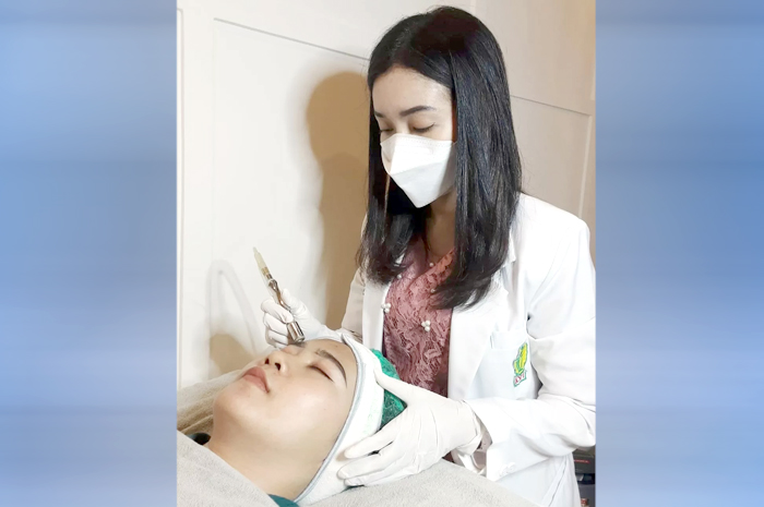 TELATEN: Dr. Yuanika Adiningtyas melakukan perawatan pada salah satu kliennya belum lama ini.