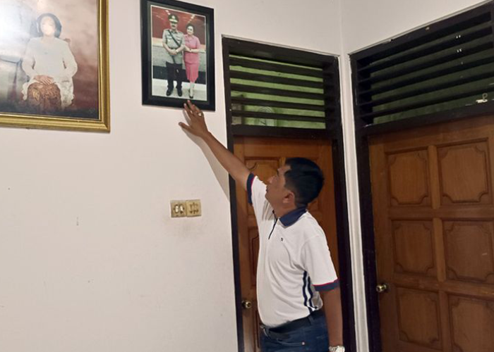 TUNJUKKAN: Adik Komjen Pol Agus Andrianto, Agus Oni Setiawan menunjukkan foto sang jenderal bersama istrinya Evi Celiyanti yang terpasang di rumah Kakak kandung mereka Sri Sudarno.