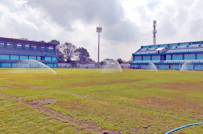 BERUBAH TOTAL: Proses penyiraman rumput dengan sprinkler pada lapangan Stadion Wergu Wetan.