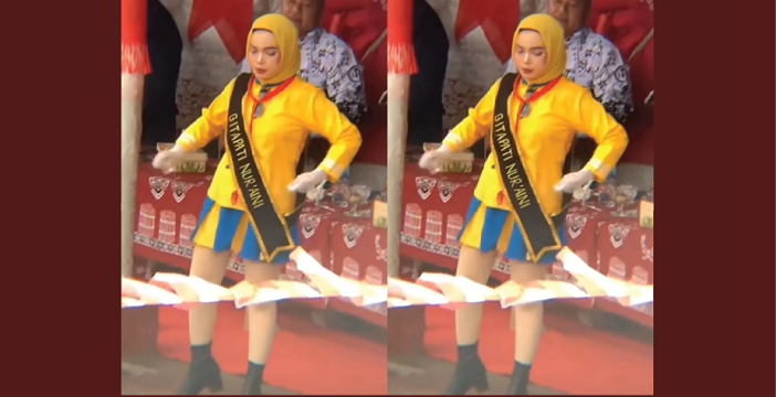 perempuan muda jilbab kuning mayoret yang tengah asyik pargoy dalam sebuah acara (instagram @magelang_raya)