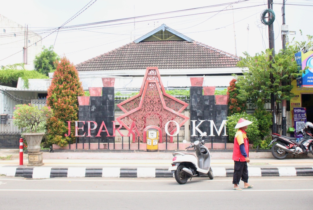 TUNAI: Tukang parkir di ruas Jalan Raya Jepara-Kudus usai menata kendaraan warga kemarin.