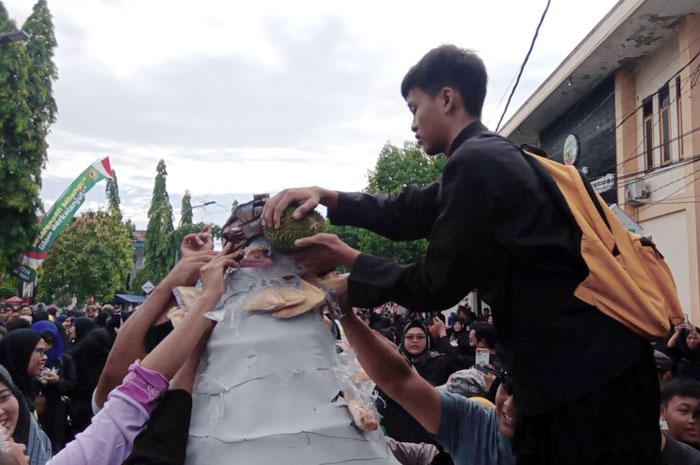 ANTUSIAS: Warga saat menaiki gunungan berebut hasil pertanian.