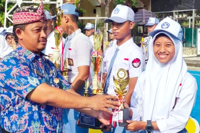 JUARA: Kepala SMAN 1 Purwodadi saat menyerahkan piala kepada emenang lomba FLS2N.