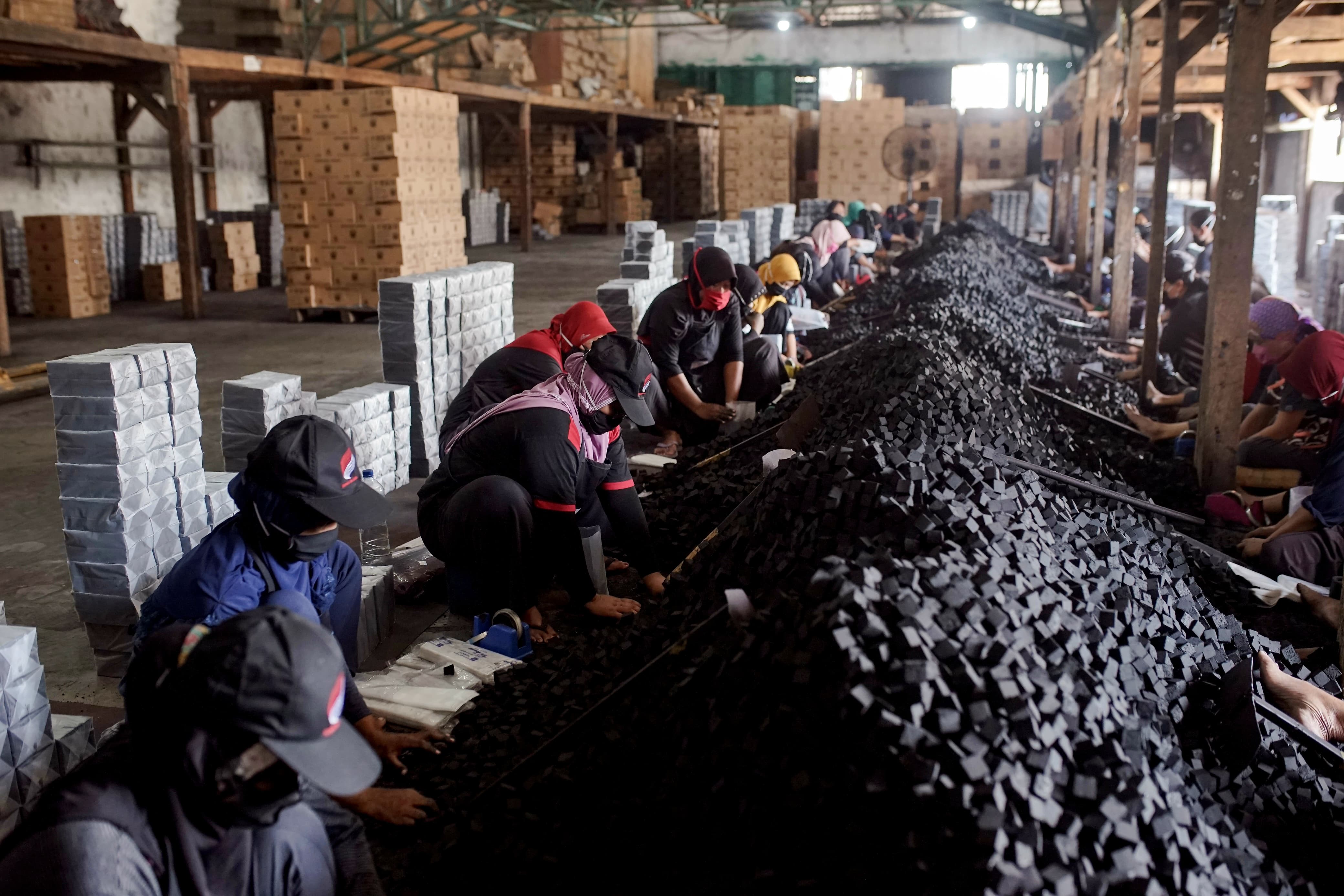 PRODUKSI: Pekerja sedang memproses briket arang batok kelapa yang ada di Desa Krangganharjo Kecamatan Toroh.
