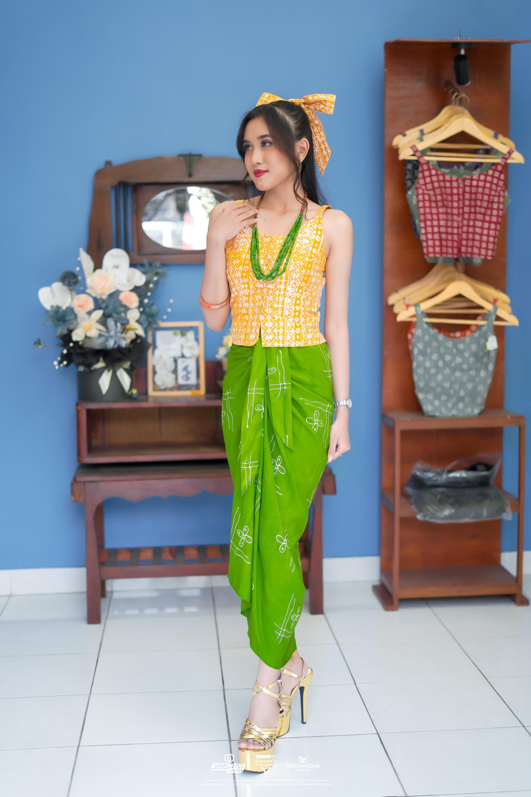 ETNIK: Sarung lilin motif Setiti Mono yang dipadukan dengan atasan kuning cerah serta twilly sebagai ikat rambut.