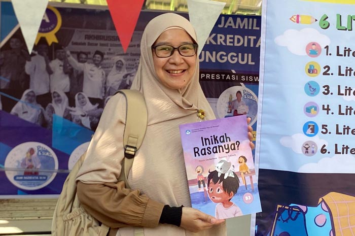 PRODUKTIF MENULIS: Lia Herliana menunjukkan salah satu buku karyanya.
