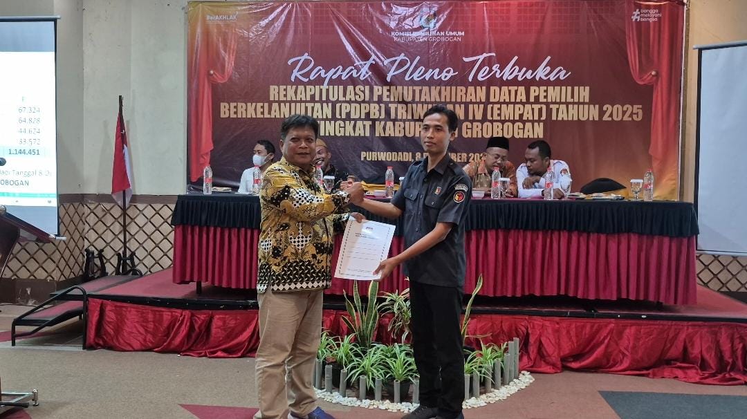 IKUT PENGAWASAN &ndash; Ketua KPU Grobogan Agung Sutopo menyerahkan salinan data PDPB Triwulan IV kepada Koordinator Divisi Pencegahan, Parmas dan Humas, Amal Nur Ngazis.
