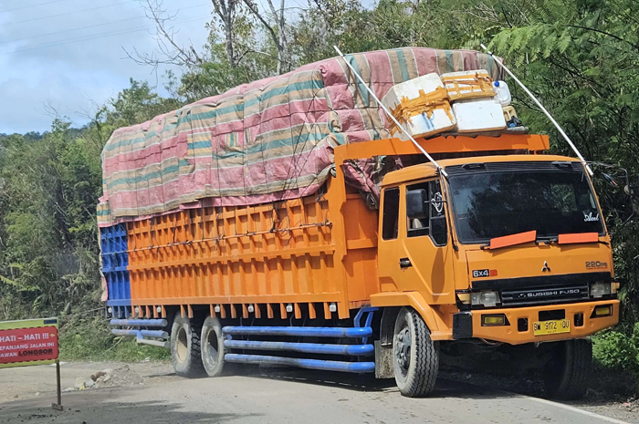 Sebuah truk melintasi Jalan Nasional Lintas Sumatra Taput Sibolga yang terdampak longsor.&nbsp;    &nbsp;