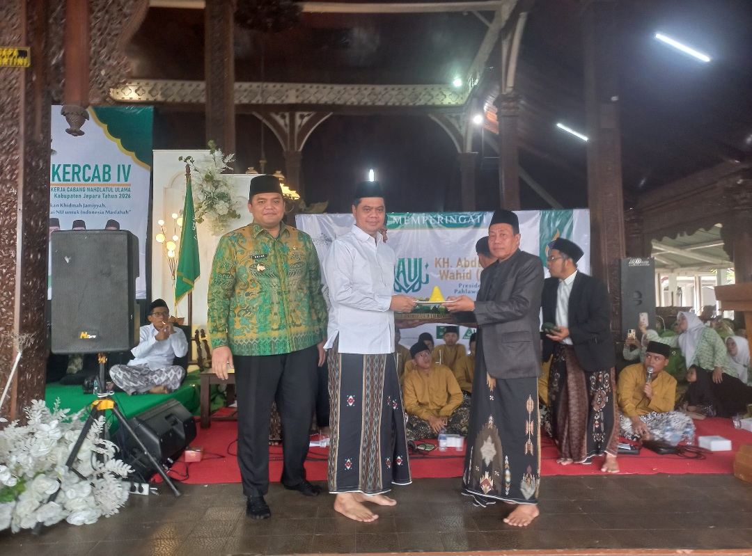HARMONIS: Bupati Jepara menyerahkan potongan tumpeng kepada Rais Syuriyah PCNU Jepara, KH. Khayatun Abdullah Hadziq.