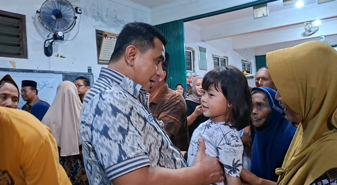 SUASANA HANGAT: Wakil Gubernur Jawa Tengah Taj Yasin Maimoen menghibur anak kecil penghuni posko pengungsian di Desa Temulus, Kec Mejobo, Selasa (13/1) malam. (ANDIKA TRISNA SAPUTRA/RADAR KUDUS)